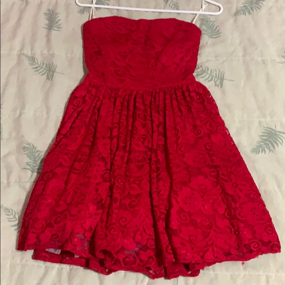 A pure red lace dress with floral designs.